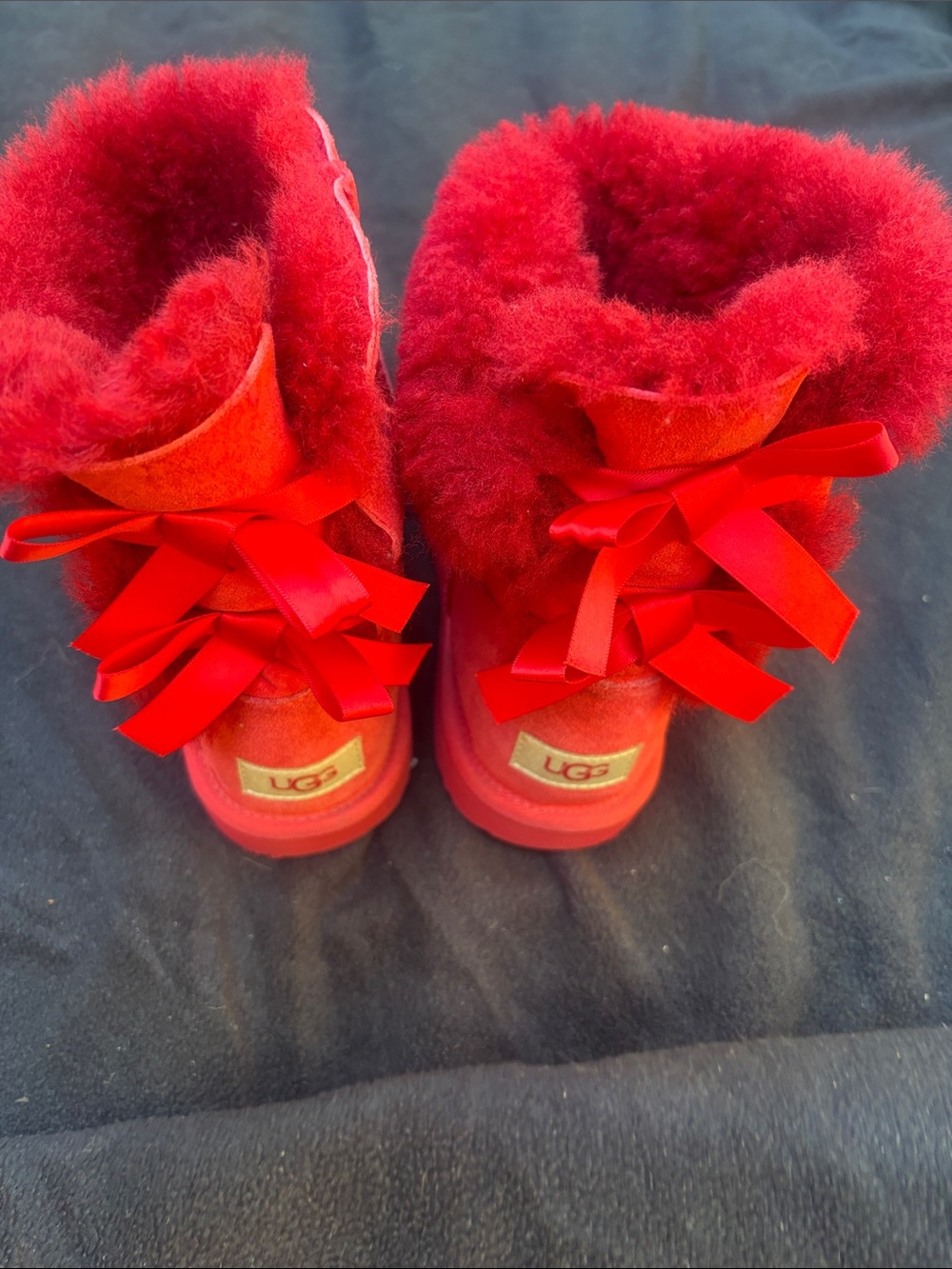 UGG Vibrant Red Shearling Bow Back Boots Water treatment. Suede top.